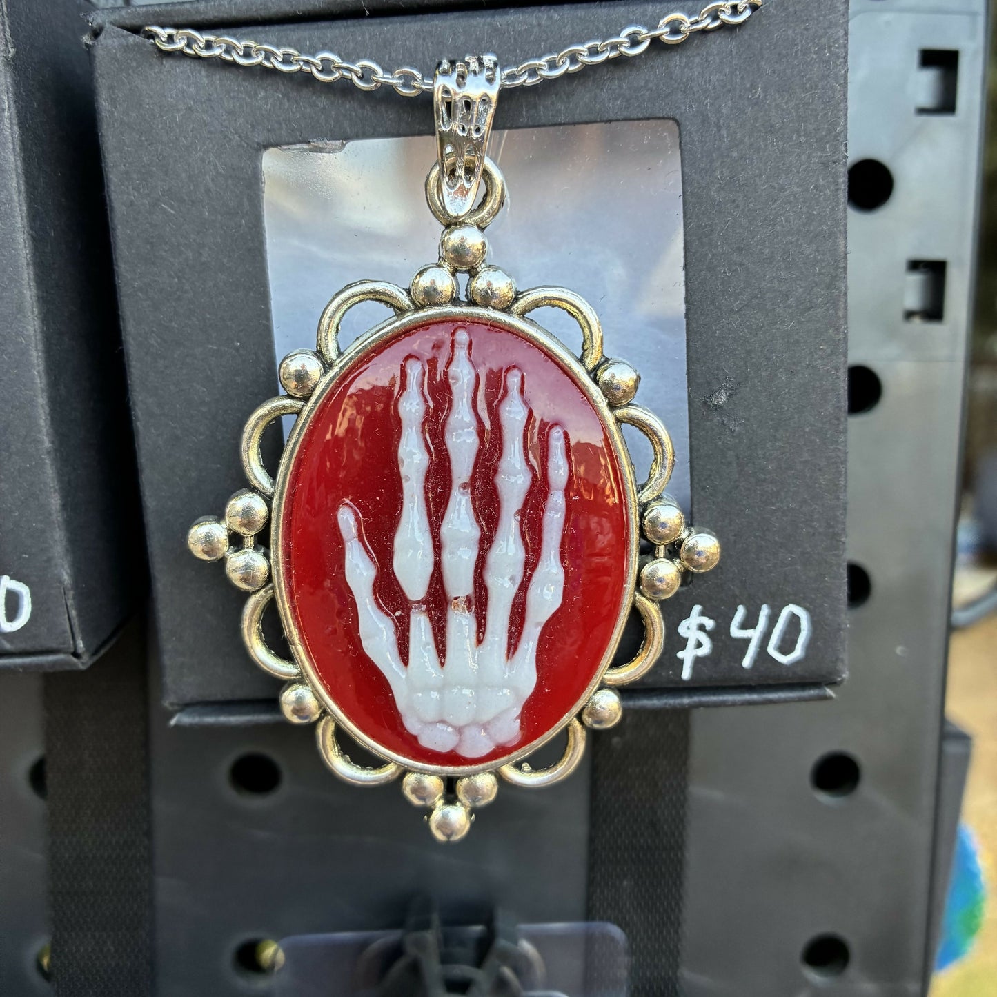 White on red skeleton hand cameo