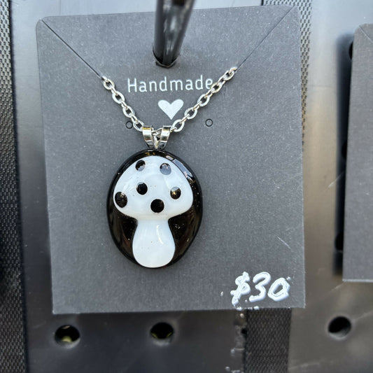 White mushroom on black oval