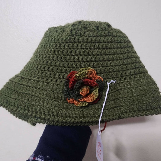 green crochet hat with flower